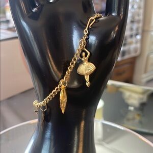 Vintage 50s charm bracelet. lightweight, gold plated with old-fashioned charms.